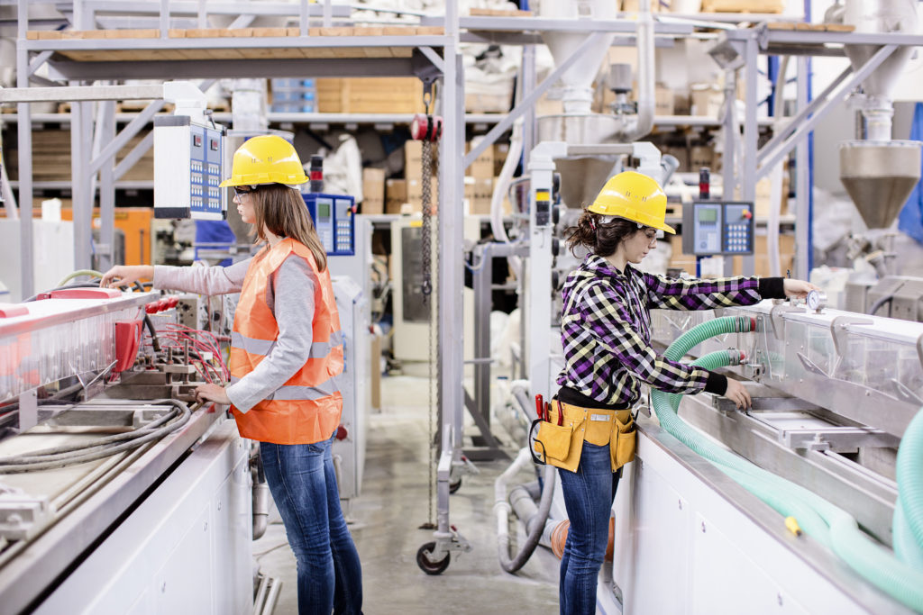 Two girls working in a factory